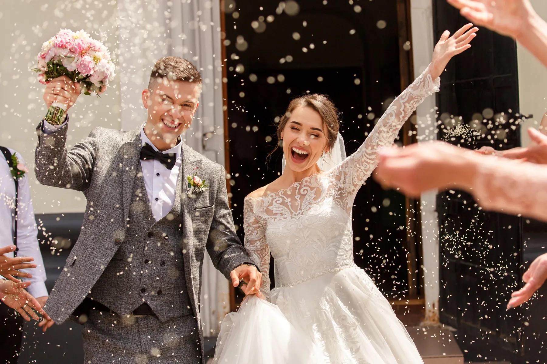 Newlyweds surrounded by guests after the ceremony