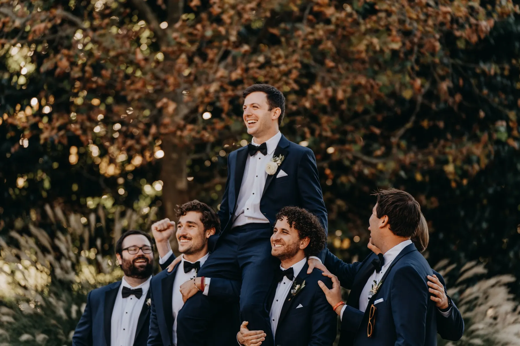 Groom surrounded by his groomsmen